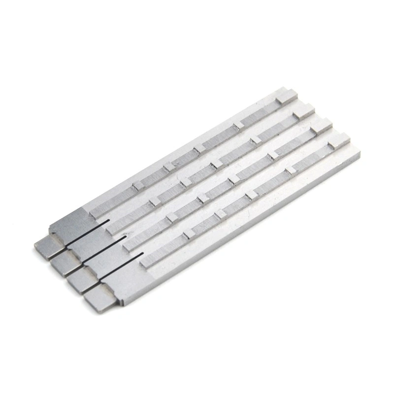 Four elongated precision machined metal inserts with parallel grooves and stepped features
